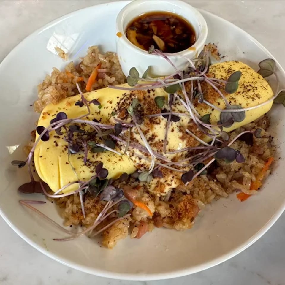 Eggs over fried rice with microgreens