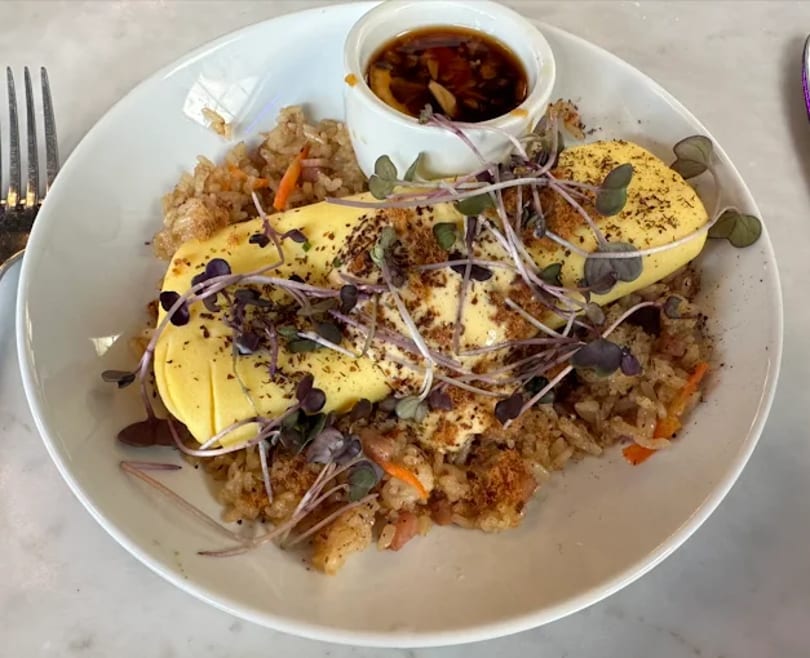 Eggs over fried rice with microgreens